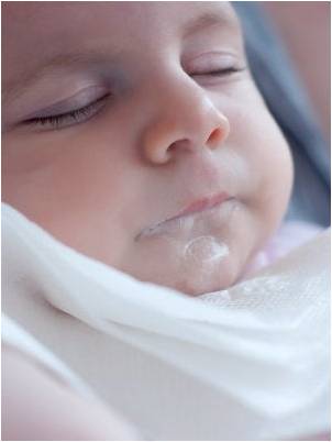 Baby with reflux while sleeping.
